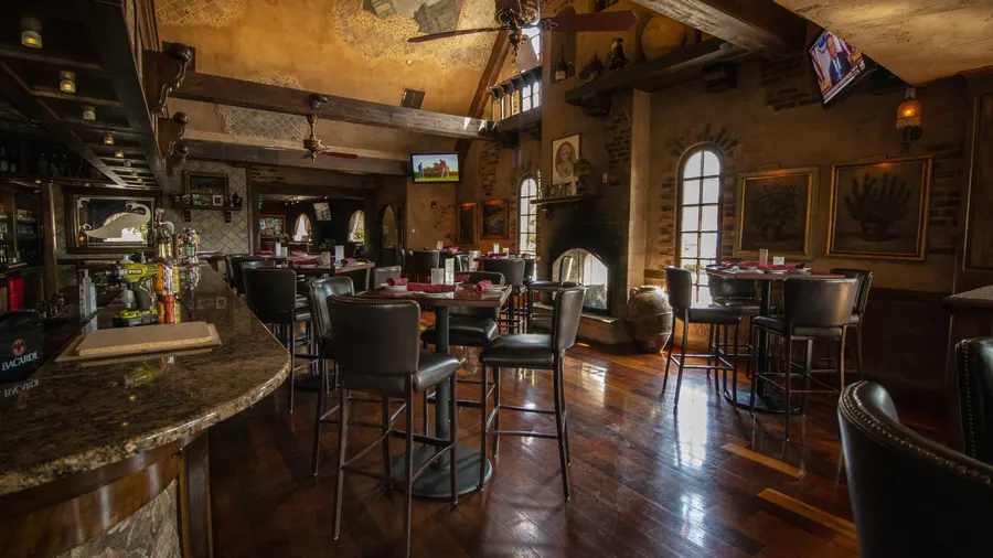 Lounge with stone fireplace and bar seating